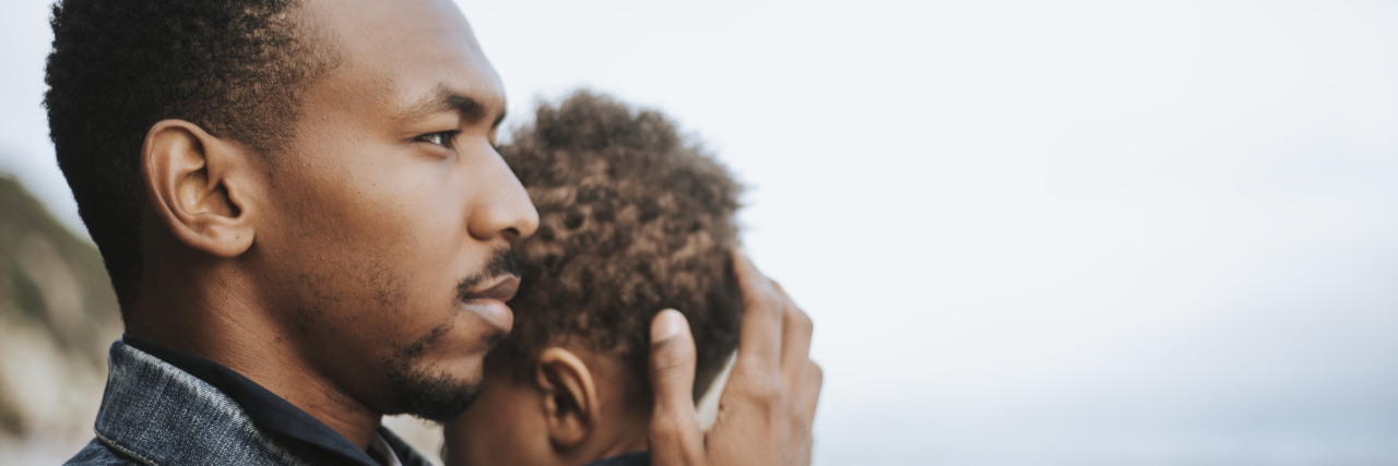 Challenges of Raising a Child Who Has Experienced Trauma a black man cradling a little boy
