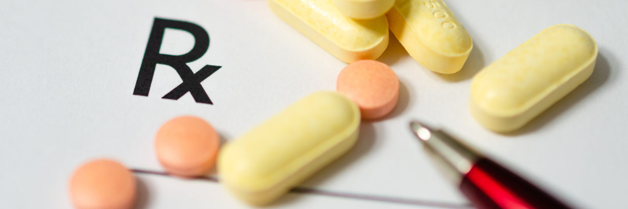 Oregon Advocates Fight to Reverse Opioid Guidelines That Cause Harm Medicines pills scattered on a prescription pad with a pen