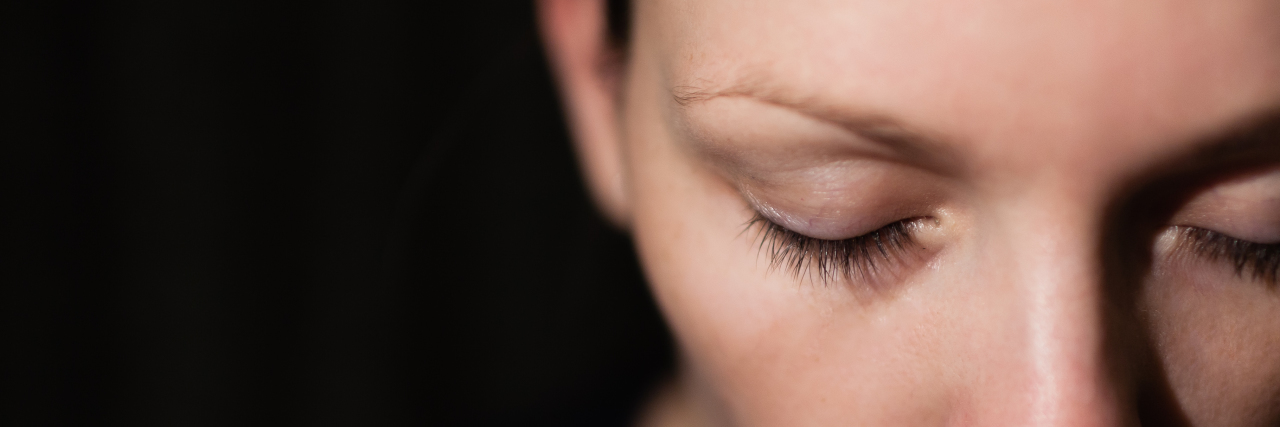 Being Stoic and Hiding Pain With a Rare Disease Sad woman looking down.