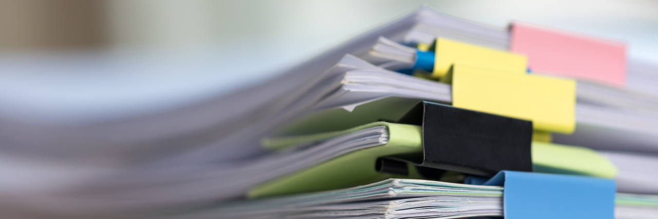 The Power of Facts When Advocating for Your Child With a Disability Stack of paperwork.