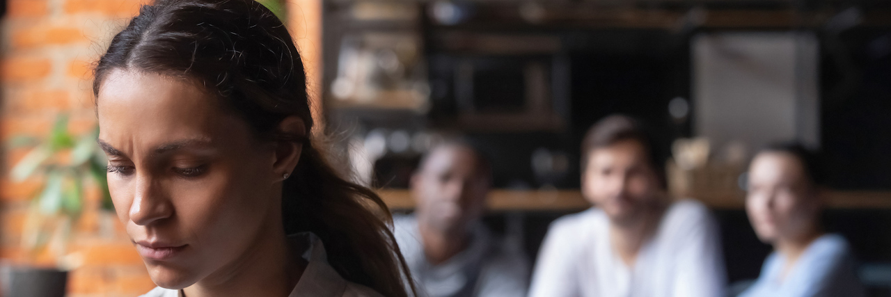 Deciding How Much to Share About My Mental Health Past Upset woman, sitting alone in cafe