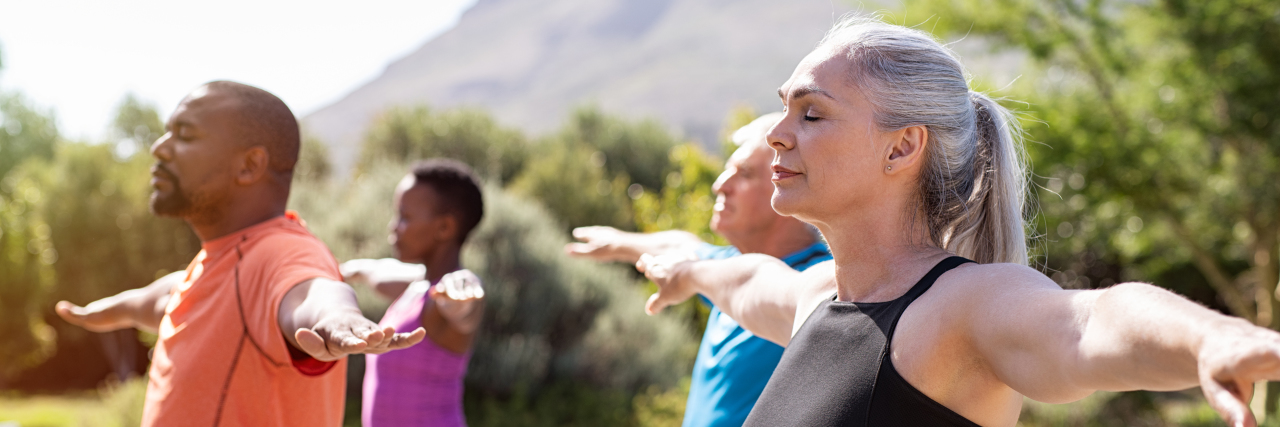 Gratitude for a Successful Year Living With Parkinson's Disease Group of people doing breathing exercise.