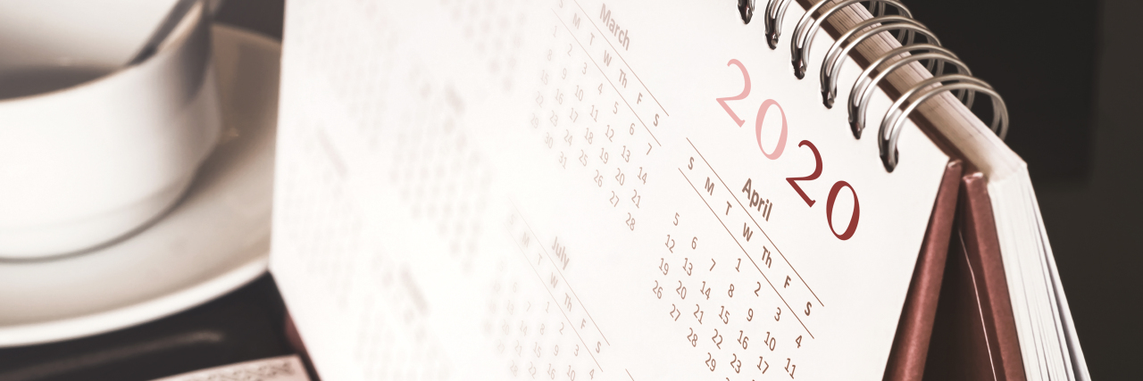 Making New Year's Resolutions With Chronic Illness Desktop calendar sitting on desk showing year 2020.