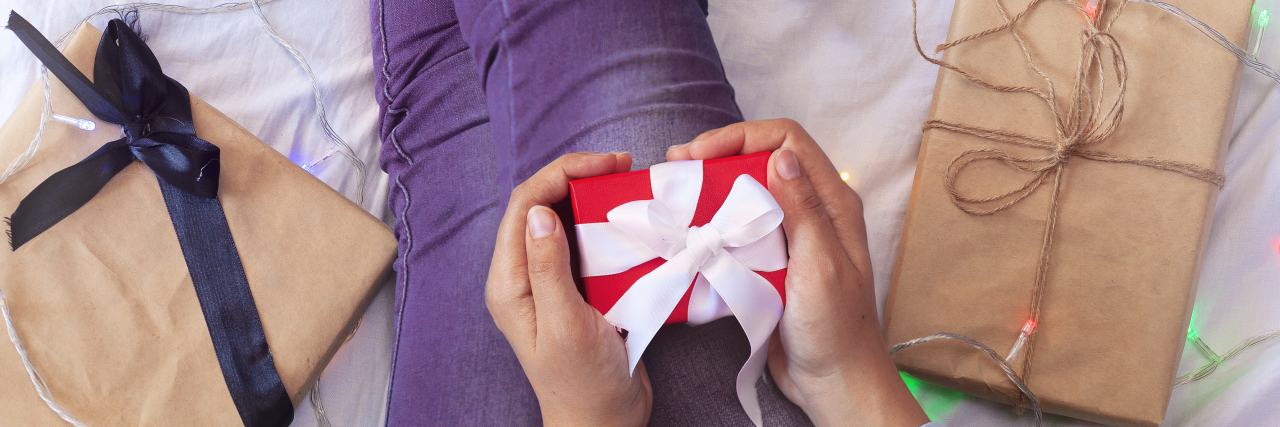 Gifts for Someone in the Hospital or Recovering From Surgery Woman in bed opening presents.
