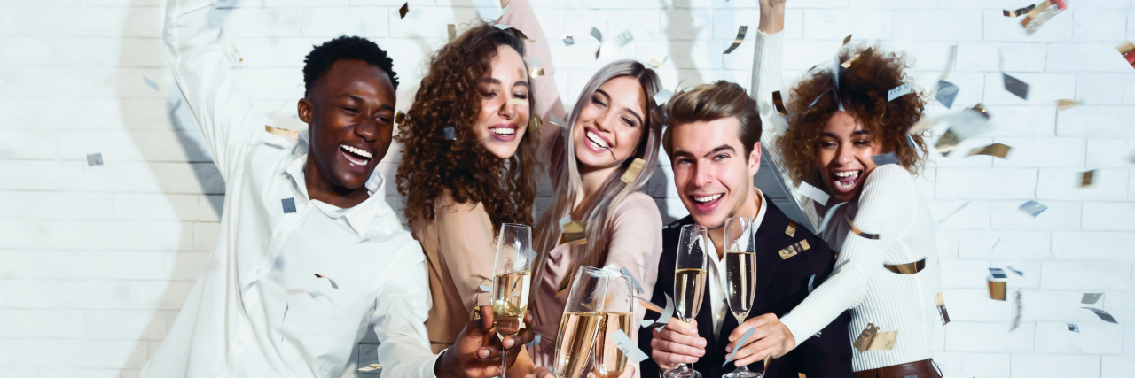 5 Things I'm Doing This New Year to Maintain My Mental Health group of friends with champagne glasses dressed up celebrating New Year's