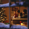 family together near a christmas tree and window