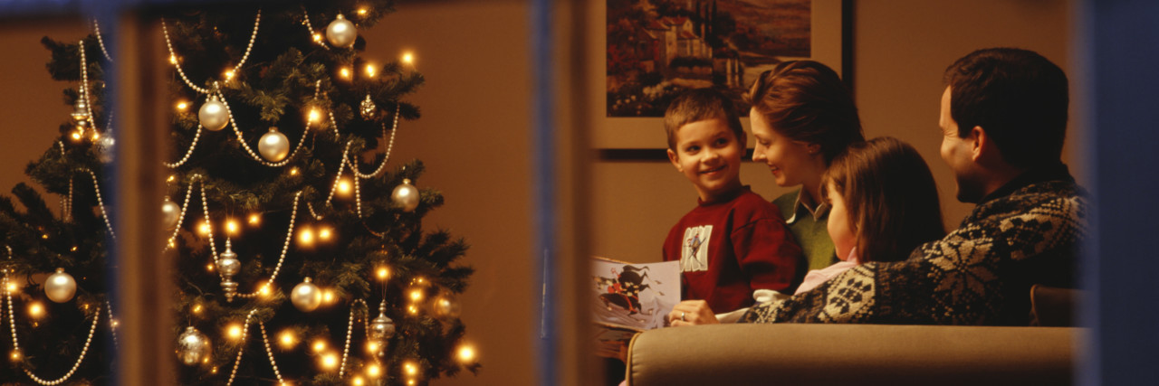 Making Accommodations for Kids With Disabilities During the Holidays family together near a christmas tree and window