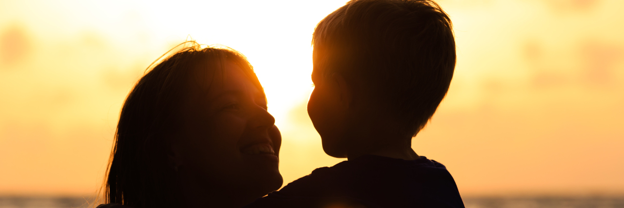 Why Unsolicited Autism Health Advice Isn't Helpful Mother and son on the beach at sunset.