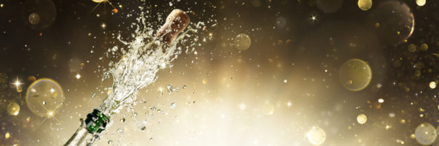 Champagne bottle with golden background.