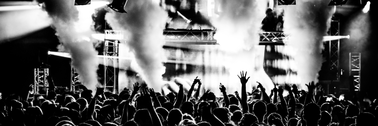 Making Concerts Accessible to People With Dwarfism Crowd standing at concert.