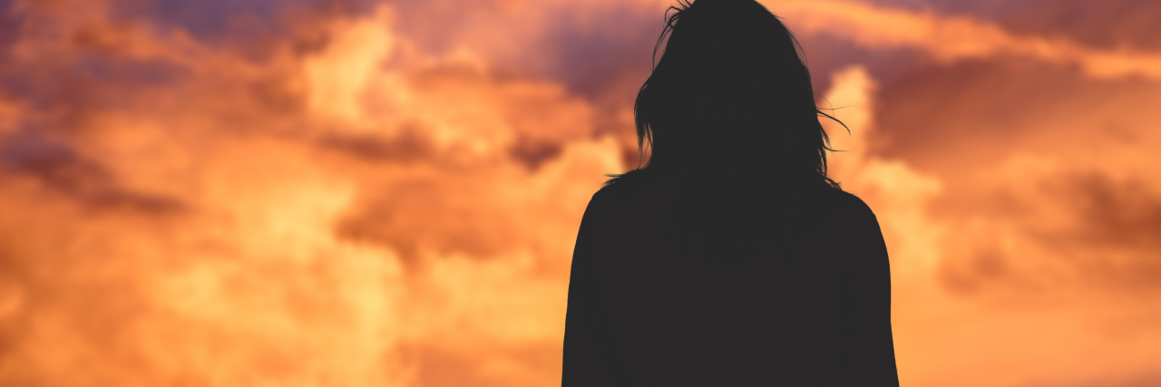 The Far-Reaching Impacts of Traumatic Brain Injury and Grief a woman watching the sky