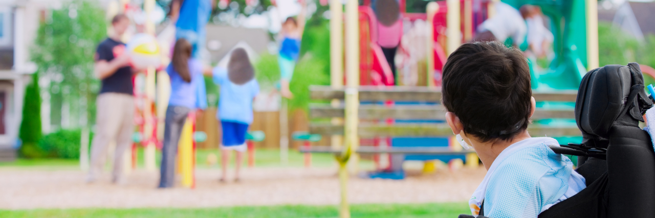Advocating for Accommodations and Asking for Help With a Disability boy with a disability watches other play on playground