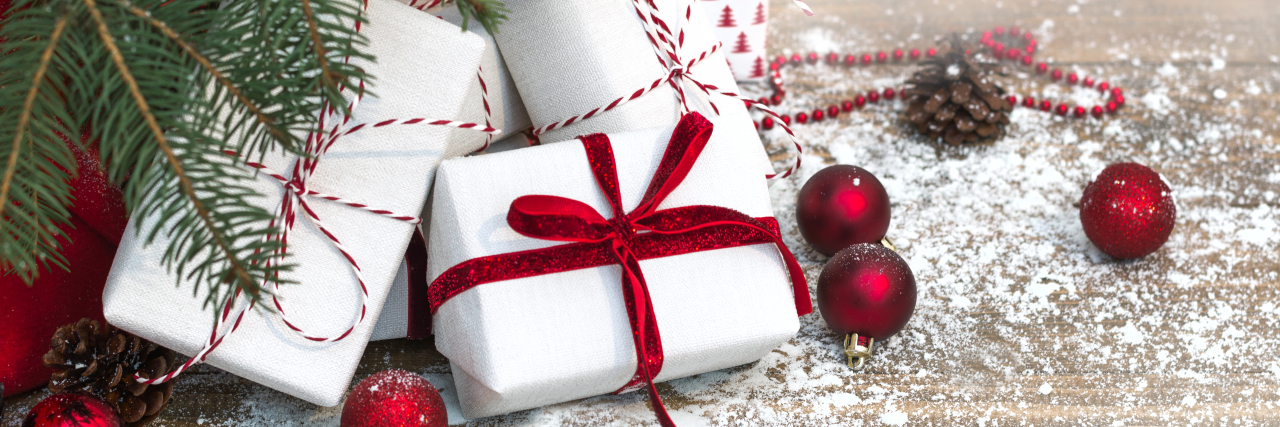 Managing the Holiday Season With Chronic Illness Gifts under Christmas tree.