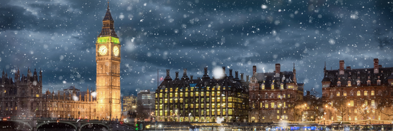 Big Ben and Westminster on a cold winter night with falling snow, London, United Kingdom