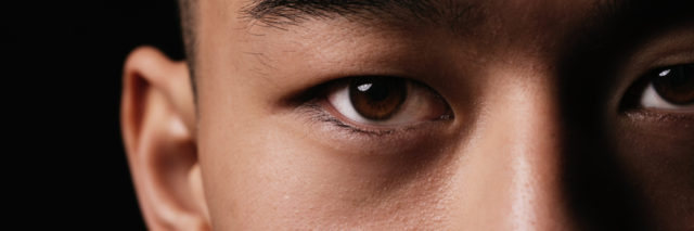 A close up photo of a man staring intensely into the camera.
