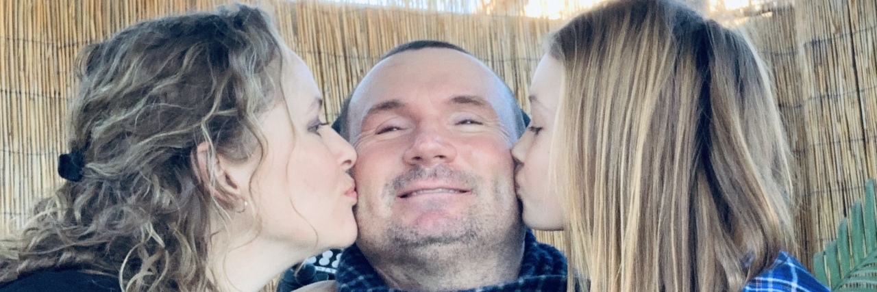 Persevering After a Spinal Cord Injury Jeff with his wife and daughter kissing him on each cheek.