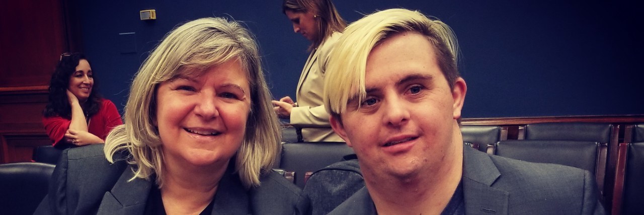 'Born This Way' Star Advocates for Disability Entrepreneurship in D.C. Sandra and Sean McElwee smile together in a Capitol Hill hearing room behind a sign that says Mr. McElwee