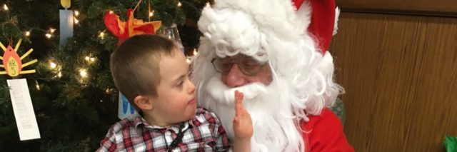 Gails son who has Down syndrome meeting Santa Claus.