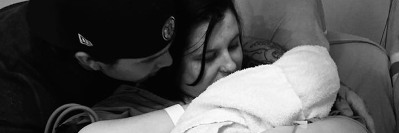 Receiving an Osteogenesis Imperfecta Diagnosis for Your Child the author and her husband holding their newborn baby