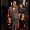 a pregnant mom is standing with her three daughters
