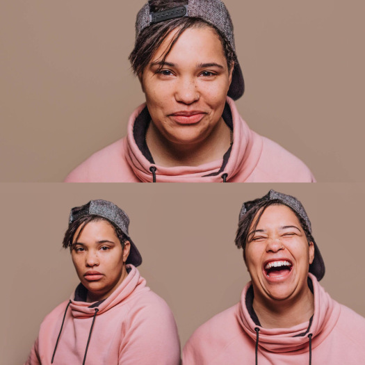 three headshots of character with various expressions. the top is smiling, the bottom left is serious and the bottom right is laughing