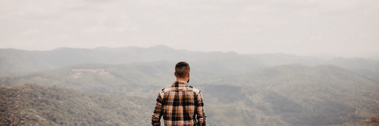 Why I’m Not Making a New Year’s Resolution to Be 'Less Depressed' A man looking over a mountain range