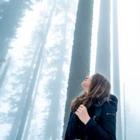 photo of woman looking up in foggy winter Sequoia National Park