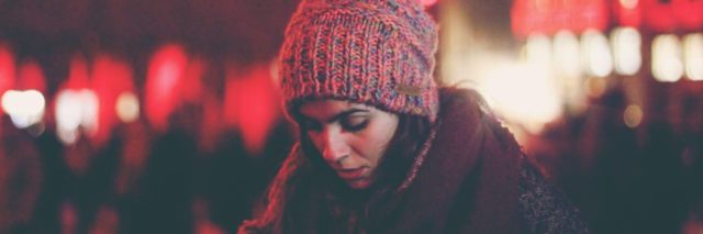 woman in a winter hat looking down