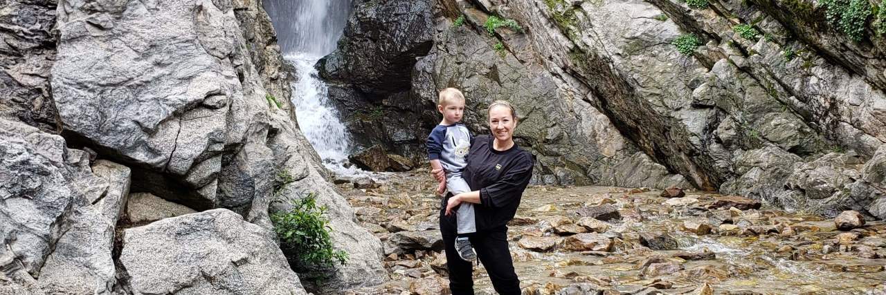 Non-Disabled People Need to Learn About Disabilities Person hiking near small waterfall.