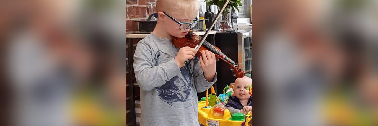 Robert playing the violin for his baby brother.