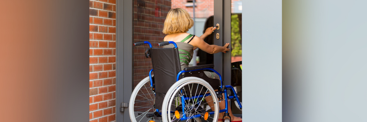 Respect Wheelchair Users Who Say 'No' When You Offer to Help Woman in a wheelchair opening a door.