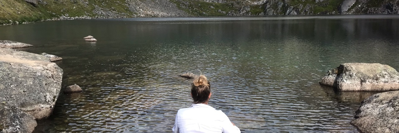 8 Tips for Leading With Courage Through Crisis Woman looking at lake.
