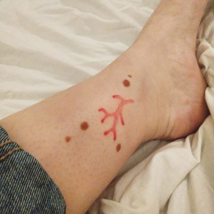 Tatiana shows off a tattoo of red coral, which is on her foot.