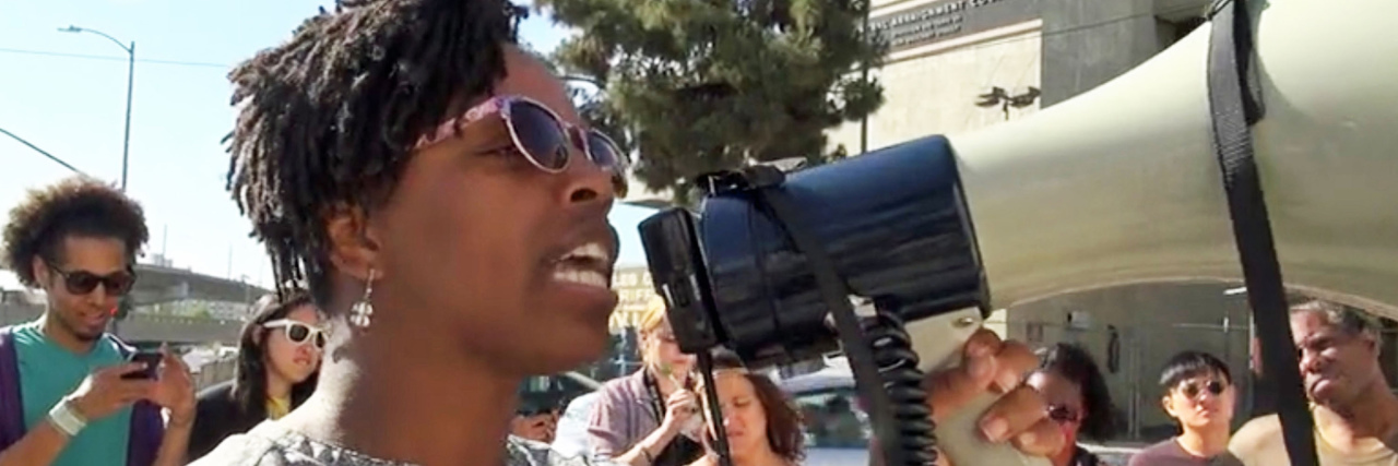 Patrisse Cullors speaks at a rally outside the Twin Towers Jail in Los Angeles County