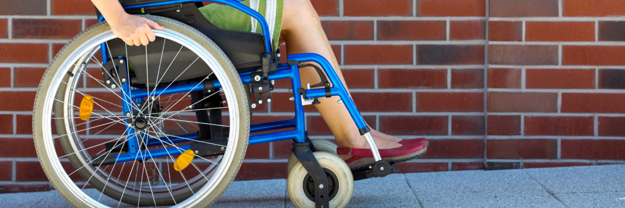 5 Misconceptions About Wheelchair Users Woman pushing herself in wheelchair.