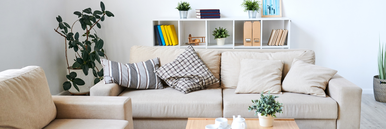 My Therapist Rearranged Her Office, but It's Still My Safe Place interior designed room, couch with pillows, table with succulents