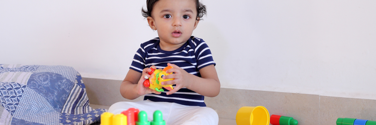 Boy playing with toys.