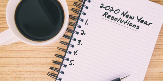 image of notebook and pen with a cup of coffee "2020 new years resolutions" written on pad