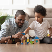Father playing blocks with his son.