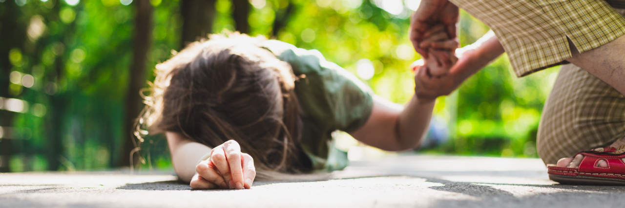 Falling Frequently Because of Charcot-Marie-Tooth Disease Woman trying to help young woman who fell.