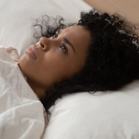 Woman lying in bed with pain.