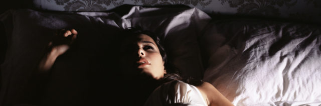 Woman lying in bed.