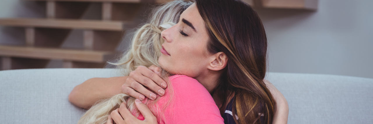 The Importance of Supporting Other Moms of Children With Disabilities a woman hugging her sad friend