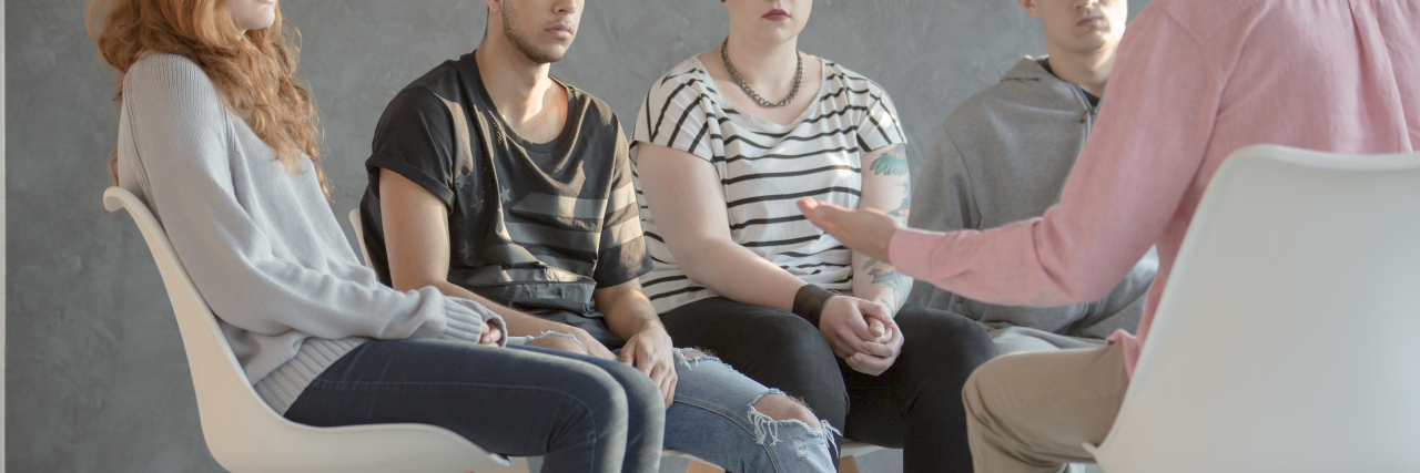 How My Stay in the Psych Ward Taught Me It's Not a Scary Place group therapy setting with 4 people sitting in chairs in a circle