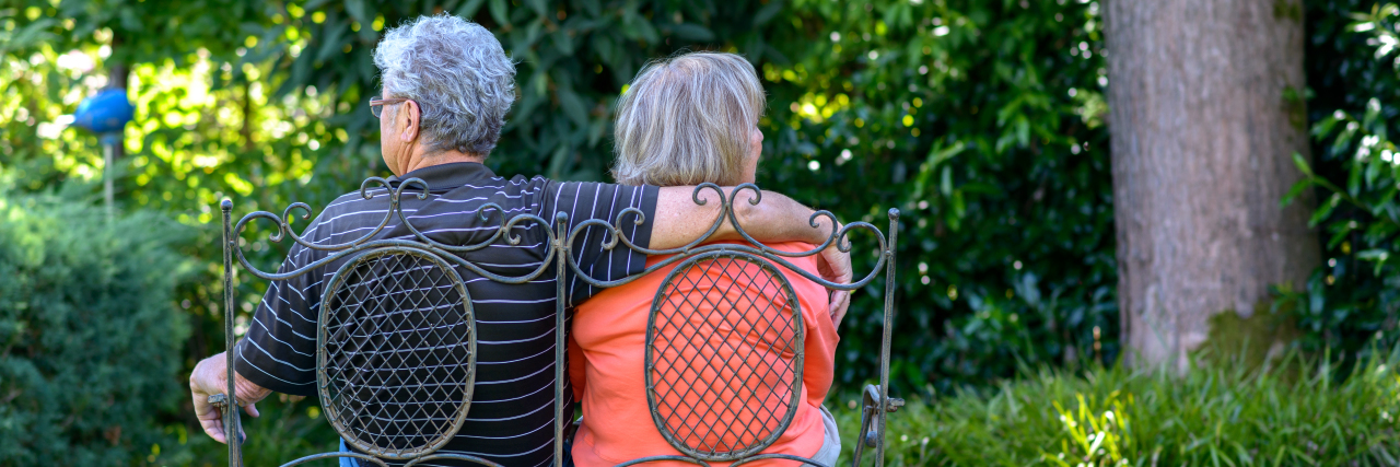 The Medical Challenges That Come With the Reality of Retirement an older couple sitting on a bench in a green garden