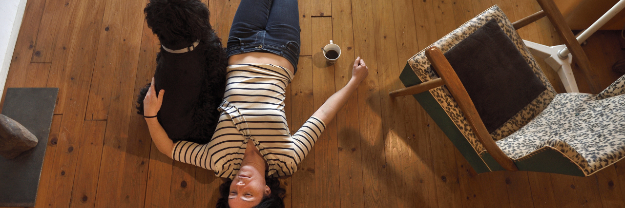 The Challenges of Living With Ehlers-Danlos Syndrome Woman lying on the floor of her house.