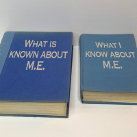 photo of three blue books. Their titles read: "What is known about M.E.," "What I know about M.E." and "What my doctors know about M.E."