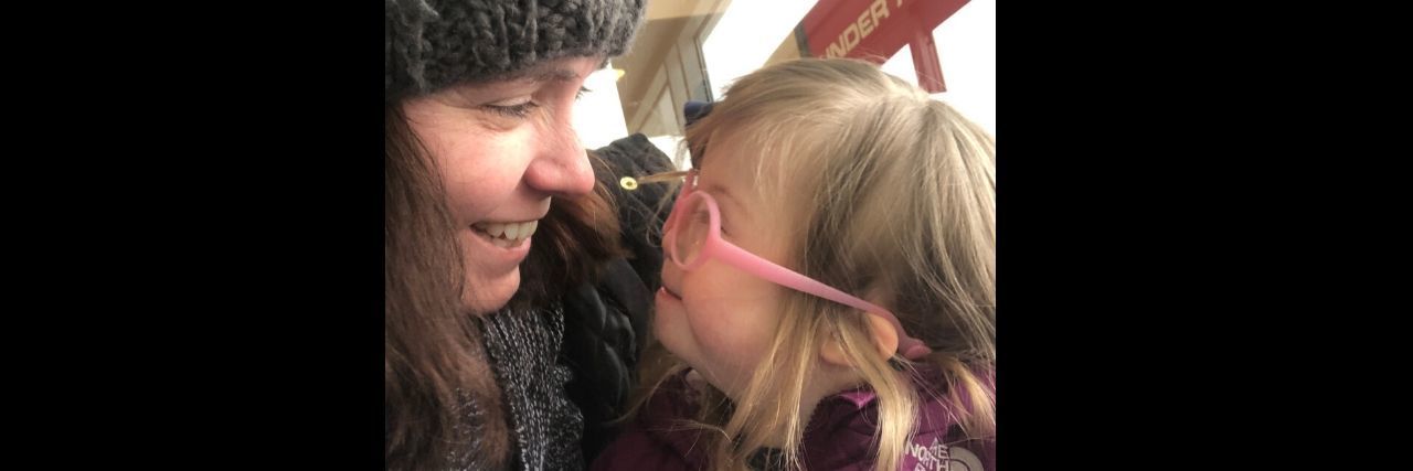 If You're a Mama to a Child With Down Syndrome, Read This A mother smiling at her daughter with Down syndrome.
