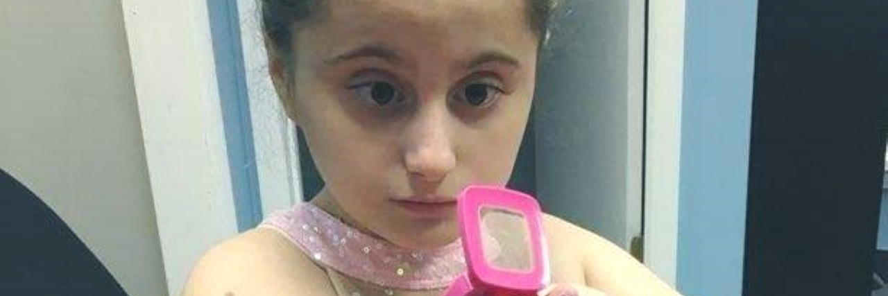 What to Do After Your Child Is Diagnosed With Autism Ballerina Caroline putting on her makeup.