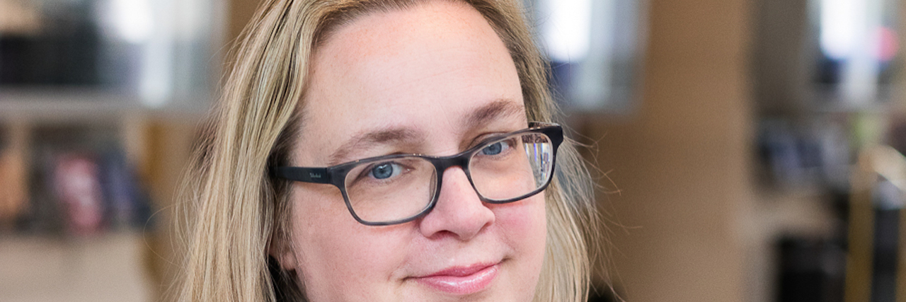 Children's Mental Health Services Are Failing Young People A woman wearing glasses and looking at the camera